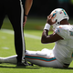 Tua Tagovailoa holds his head during Sunday’s win over the Bills.